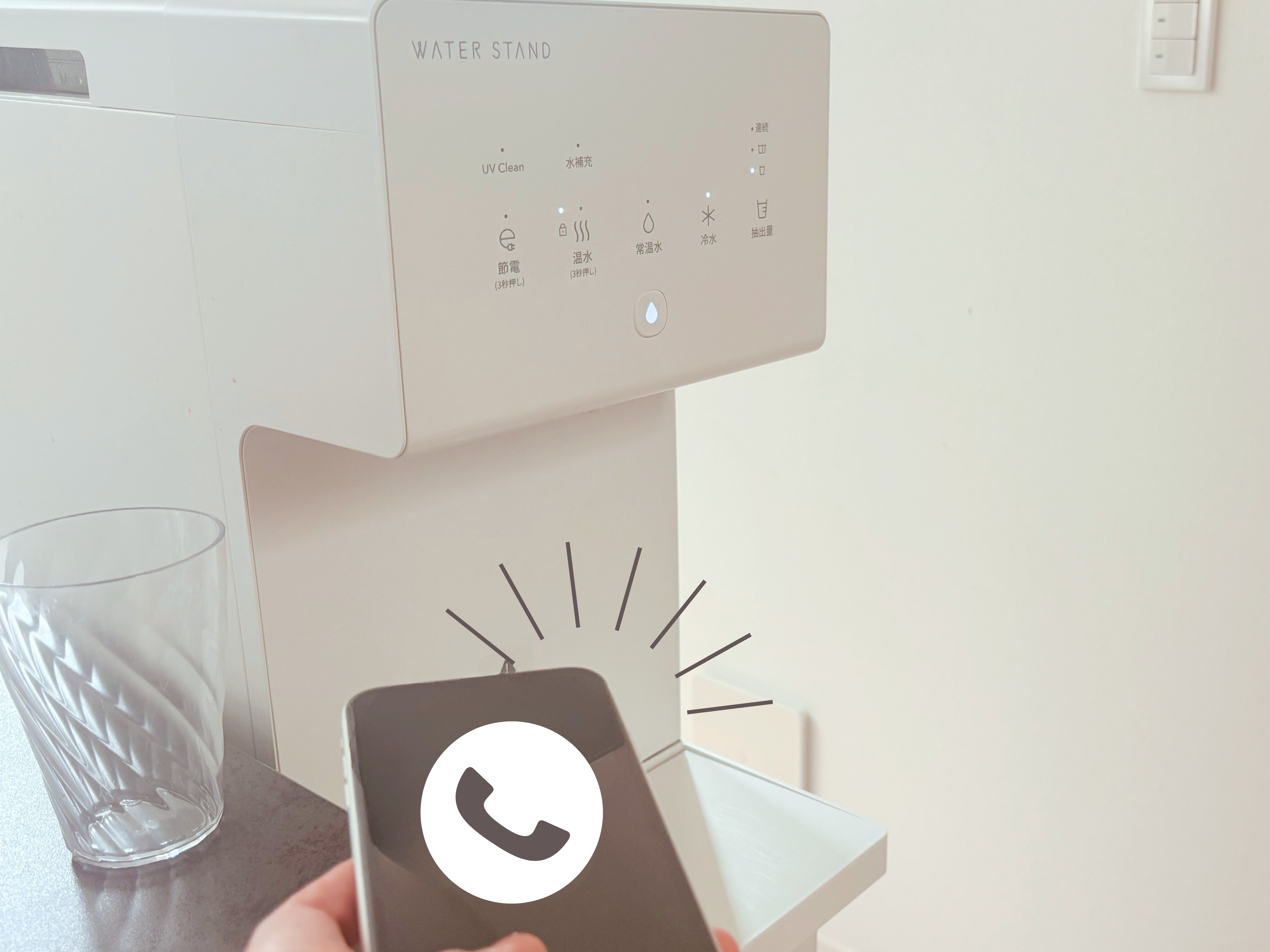 ウォータースタンド ピュアライフ の前で電話をかける様子